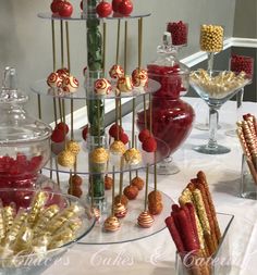 there are many candy and candies on the table in front of the glass vases