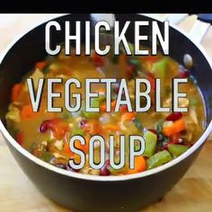 chicken vegetable soup in a pan on a wooden table with the words, chicken vegetable soup