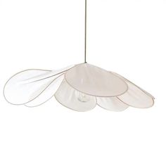 a white light hanging from the ceiling with three wings on it's back end