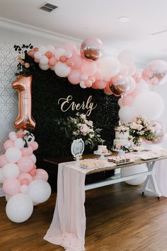 a table with balloons and cake on it