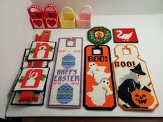 cross stitch bookmarks are laid out on a table