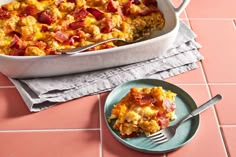 a casserole dish on a plate with a fork next to the casserole