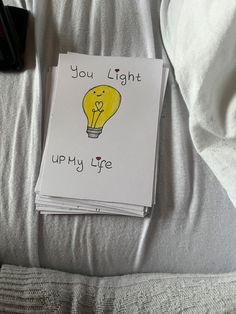 an open book with a yellow light bulb on it