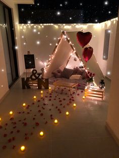 a room decorated with candles and lights for valentine's day or other special occasion