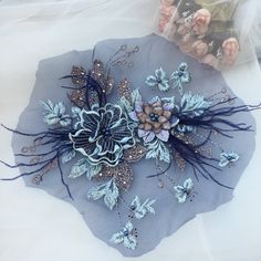 there is a piece of fabric with flowers on it and some other things in the background