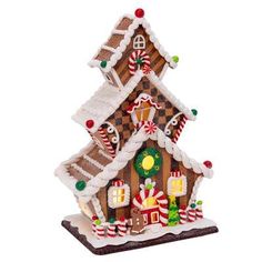 a gingerbread house ornament on a white background