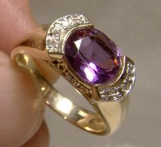 "A 14k oval amethyst with 12 diamonds ring from the 1980s.  This vintage size 5-3/4 or 5.75 yellow gold ring features a genuine oval faceted amethyst gem stone with twelve genuine diamonds.  It measures 1/2\" x 5/16\" across the upper setting. It is marked  14K with a KCJ makers mark. It is also marked 585 which is another designation for 14k.  It weighs 4.6 grams.   It features two arcs of five single point diamonds at each side of the amethyst. This lovely purple February birthstone has had th Rings For Engagement, 1920s Engagement Ring, Golden Rings, Amethyst And Diamond Ring, Purple Jewelry, Amethyst Gem, Diamonds Ring, Purple Band, 18k Gold Jewelry