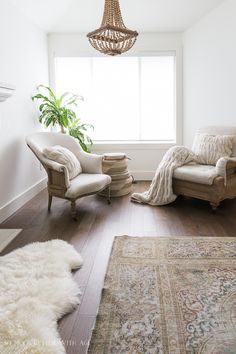 a living room filled with furniture and a rug