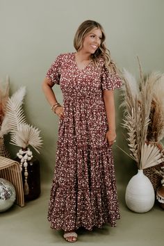 We are adoring the delicate floral pattern on this dress that makes it stand apart from the rest. Our Many Moments Floral Maxi Dress features a v-neckline, elastic waistband, cap flutter sleeves, and a three tiered design skirt. A true essential that transitions flawlessly throughout the seasons! Neckline: V-neckline Fabric: 100% Polyester Details: Lined, Elastic waistband, delicate floral print, tiered skirt Imported Fit: True to size; relaxed fit- Arms: Relaxed flutter sleeve- Chest: Relaxed- Modest Floral Print Dress For Fall, Brown V-neck Dress For Garden Party, Brown Floral Print V-neck Dress, Flowy Short Sleeve Maxi Dress For Fall, Fall Flowy Maxi Dress With Ditsy Floral Print, Flowy Brown Printed Maxi Dress, Modest Floral Print Vacation Dresses, Modest Floral Print Maxi Dress For Fall, Fall Ditsy Floral Maxi Dress