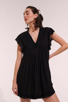 The Sasha dress from Poupette St. Barth is one of their best selling silhouettes. It has a trapeze shape with a striking fringed v-neck, butterfly sleeves, and a curved double hem trimmed in lace. 100% eco-responsible Viscose Hand wash cold. Hang dry. Made in Indonesia Women Sundresses, Poupette St Barth, Button Outfit, Mini Dress Black, Mini Dresses For Women, St Barth, Butterfly Sleeves, Sweaters And Leggings, Classic Dress