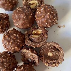 chocolate covered donuts with walnuts and nutcrackers in the middle on a white plate