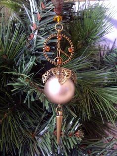 an ornament hanging from the top of a christmas tree