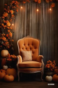 an orange chair sitting in front of a wall with pumpkins