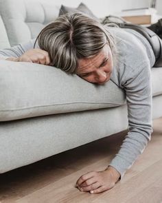 a man laying on the floor with his head down