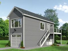 a two story garage with stairs leading up to the second floor and an attached loft