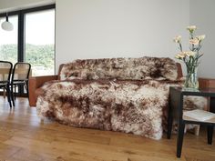 a living room filled with furniture next to a dining room table and window covered in white flowers