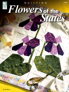 the cover of quilting flowers of the states, with scissors and tape on it