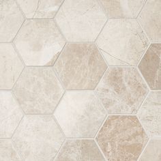 a white and beige tile floor with hexagonal tiles on the bottom one side