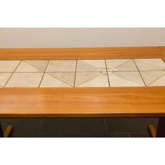 a wooden table with white tiles on it