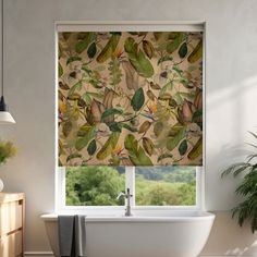 a bathroom with a bathtub and window covered in green leafy blinds next to a potted plant