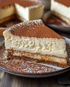 a piece of cheesecake on a plate with powdered sugar and chocolate toppings