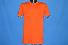 Chest 16.5 in. Length 28 in. Content: 50/50 cotton/polyester Tag Brand: Stedman This is a solid blank bright orange t-shirt made by Stedman. It is deadstock, never worn. The tag says medium but this shirt fits a modern adult unisex small. 17-07-76530 Blank T Shirt, Orange T Shirt, Blank T Shirts, Orange T Shirts, Philadelphia Pa, Bright Orange, High Neck Dress, Short Sleeve Dresses, T Shirts