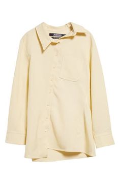 The asymmetric placket of this butter-yellow shirt shifts the collar, J-shaped chest pocket, hem and drape of the back box pleat slightly off-kilter. Asymmetric front-button closure Asymmetric point collar Long sleeves with one-button cuffs Chest patch pocket 88% viscose, 12% polyester Dry clean Imported Designer Clothing Elegant Yellow Collared Shirt, Elegant Yellow Collared Blouse, Elegant Yellow Workwear Shirt, Yellow Spread Collar Shirt For Work, Chic Yellow Collared Blouse, Classic Yellow Long Sleeve Blouse, Classic Long Sleeve Yellow Blouse, Chic Yellow Collared Shirt, Classic Yellow Collared Blouse