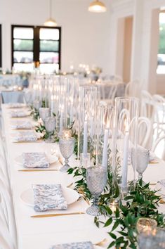 a long table is set with candles and place settings