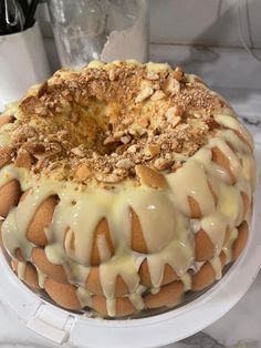 a cake sitting on top of a white plate covered in frosting and toppings