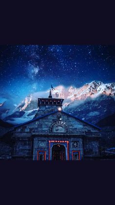 people are standing in front of a church under the night sky with mountains and stars