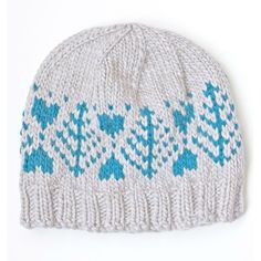 a knitted hat with blue and white designs on the front, against a white background