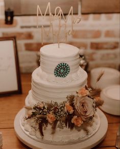 a white wedding cake with flowers on top