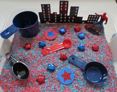 the spiderman sensory box is filled with toys and other things to make it look like