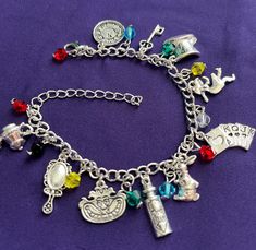 Charms adorn this silver toned bracelet all inspired by the Alice in Wonderland story. Makes for a memorable gift to anyone who loves the story. Wonderland Jewelry, Charm Bracelet Charms, Alice In Wonderland Gifts, Alice And Wonderland, Alice In Wonderland Inspired, Costume Inspo, Bracelet Charms, Silver Chain Bracelet, Bracelet Argent