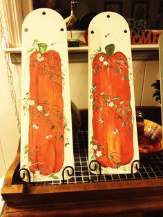 two painted pumpkins sitting on top of a shelf