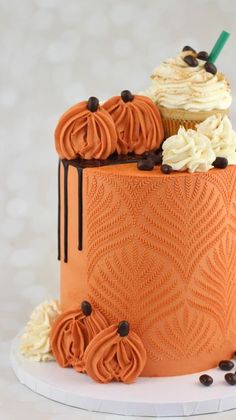 an orange cake with frosting and chocolate decorations