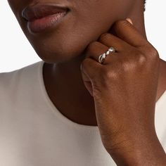 a close up of a person wearing a ring on their finger and looking at the camera