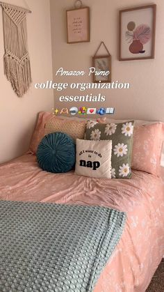 a college dorm room with pink and blue bedding, pillows and pictures on the wall