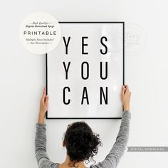 a woman holding up a poster with the words yes you can on it in front of her