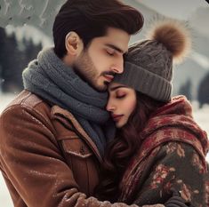 a man and woman embracing each other in the snow