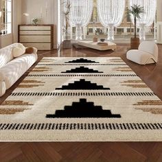 a living room with white couches and rugs