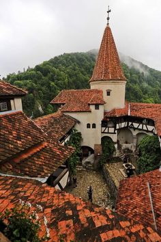 an aerial view of a building with red tile roofs