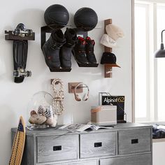 there is a shoe rack with shoes on it and other items hanging from the wall