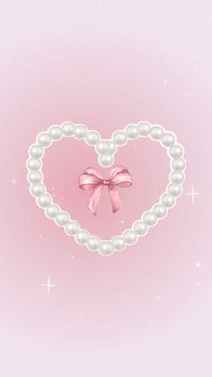 a heart shaped frame with pearls and a pink bow