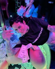 a woman sitting on top of a table covered in money