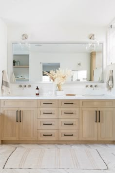 a large bathroom with two sinks and mirrors