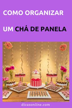 a table topped with cakes and desserts on top of a wooden table covered in pink flowers