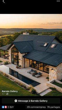 an aerial view of a house with a pool in the foreground and patio on the other side