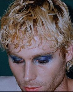 a man with blonde hair and blue eyes