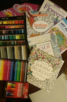 many books and crayons are laying on the table next to eachother